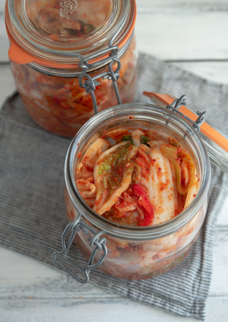 Idealy fermented napa cabbage kimchi is in a glass jar