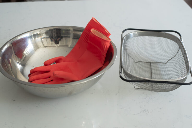 Kitchen rubber gloves, large mixing bowl, and strainer is needed to make kimchi