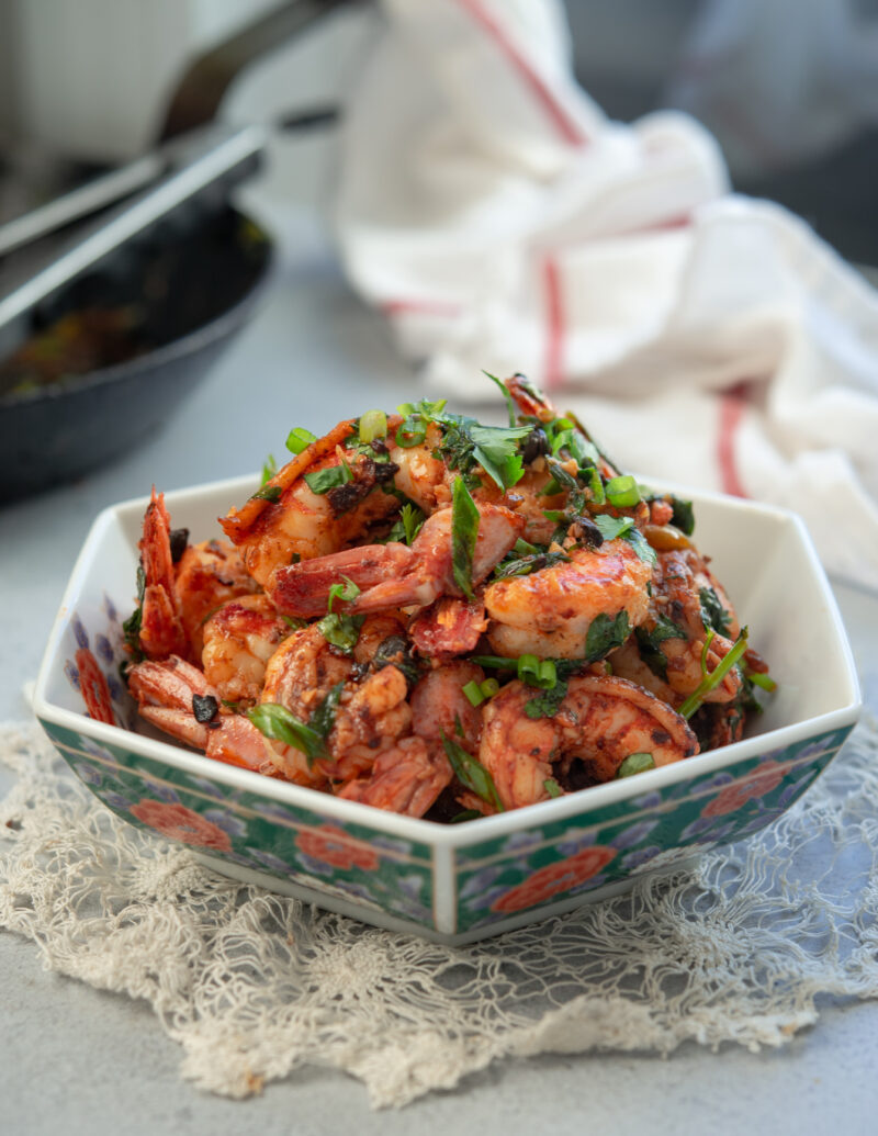 A bowl of chili garlic shrimp is made with Chinese chili crisp.