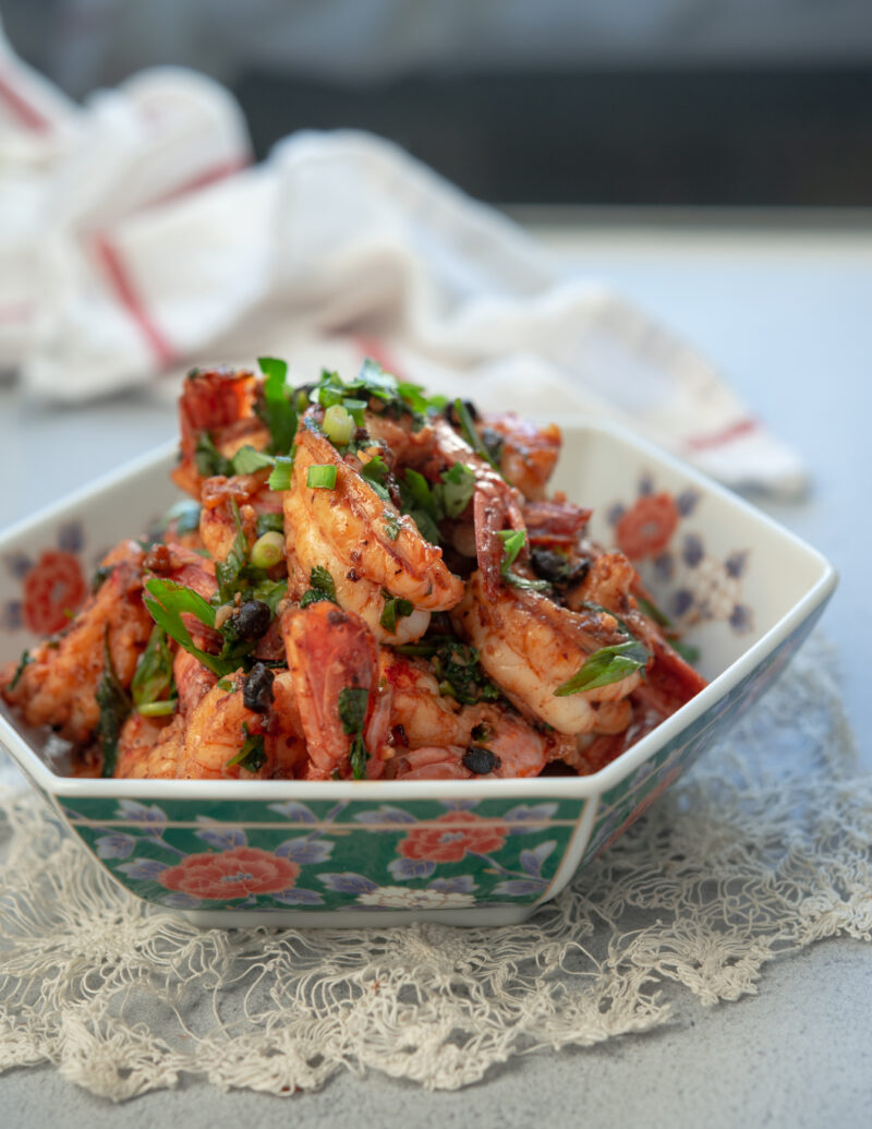 Chili garlic shrimp made with chili crisp is garnished green onion.