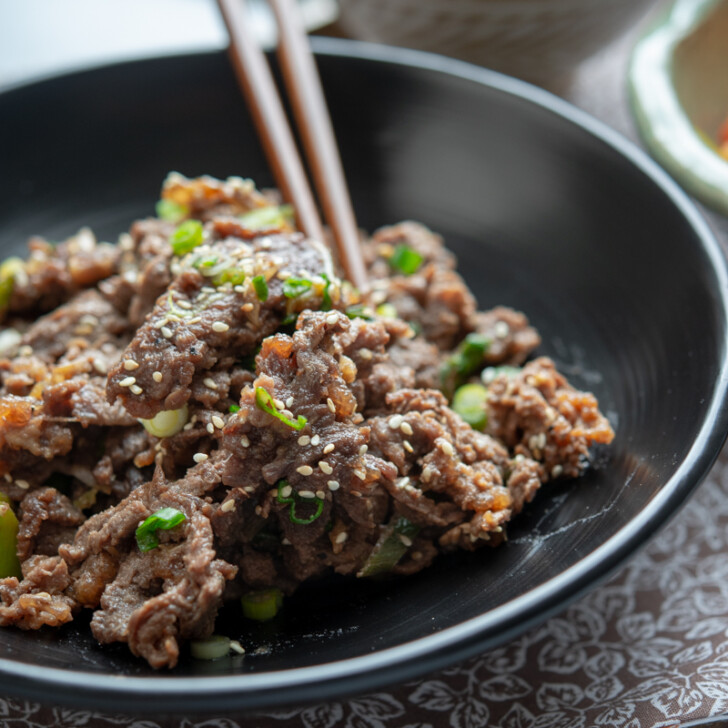 Thin slices of Korean beef bulgogi is cooked to perfection and tender.