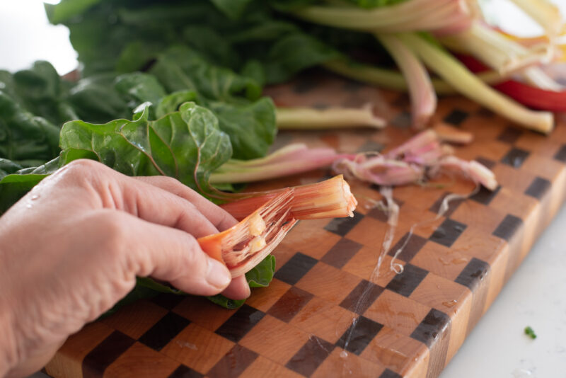 Snapping the tip of stem of Swiss chard on the back helps peel away the stringy bits.