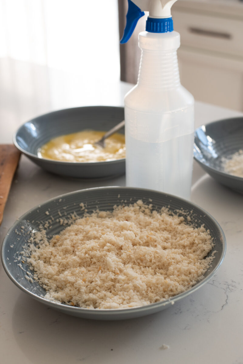 Panko breadcrumbs are moistened with water spray.