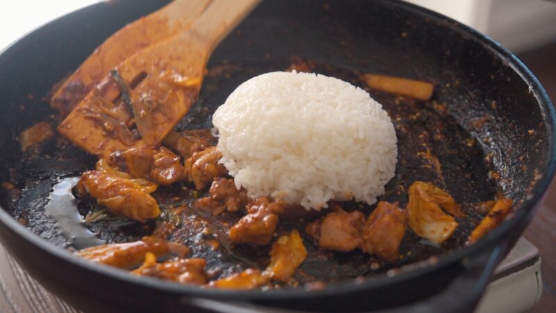 At the end or serving, rice is added to stir-fry with the remaining  pieces of dakgalbi.