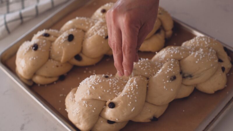 Sprinkling pear sugar on top of cardamom bread dough.