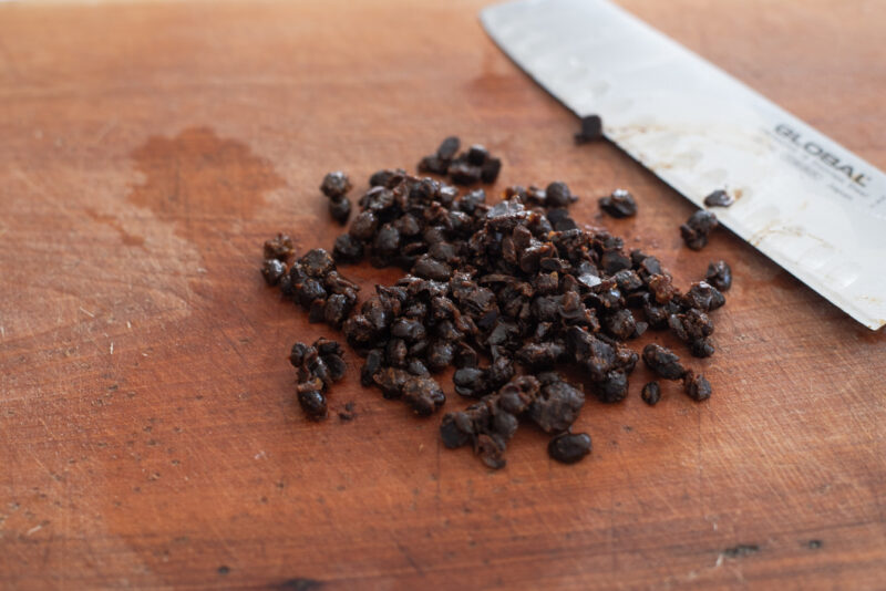 Chinese fermented black beans are roughly chopped.
