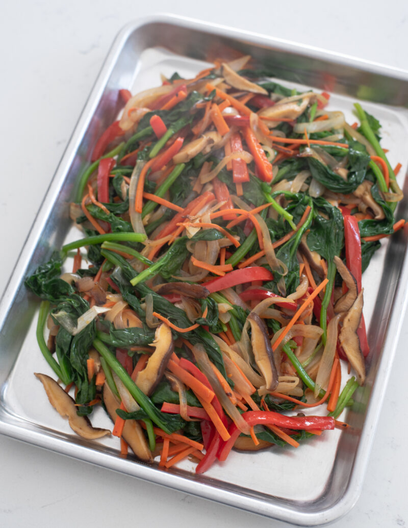 Stir-fried vegetables are cooling in a platter.