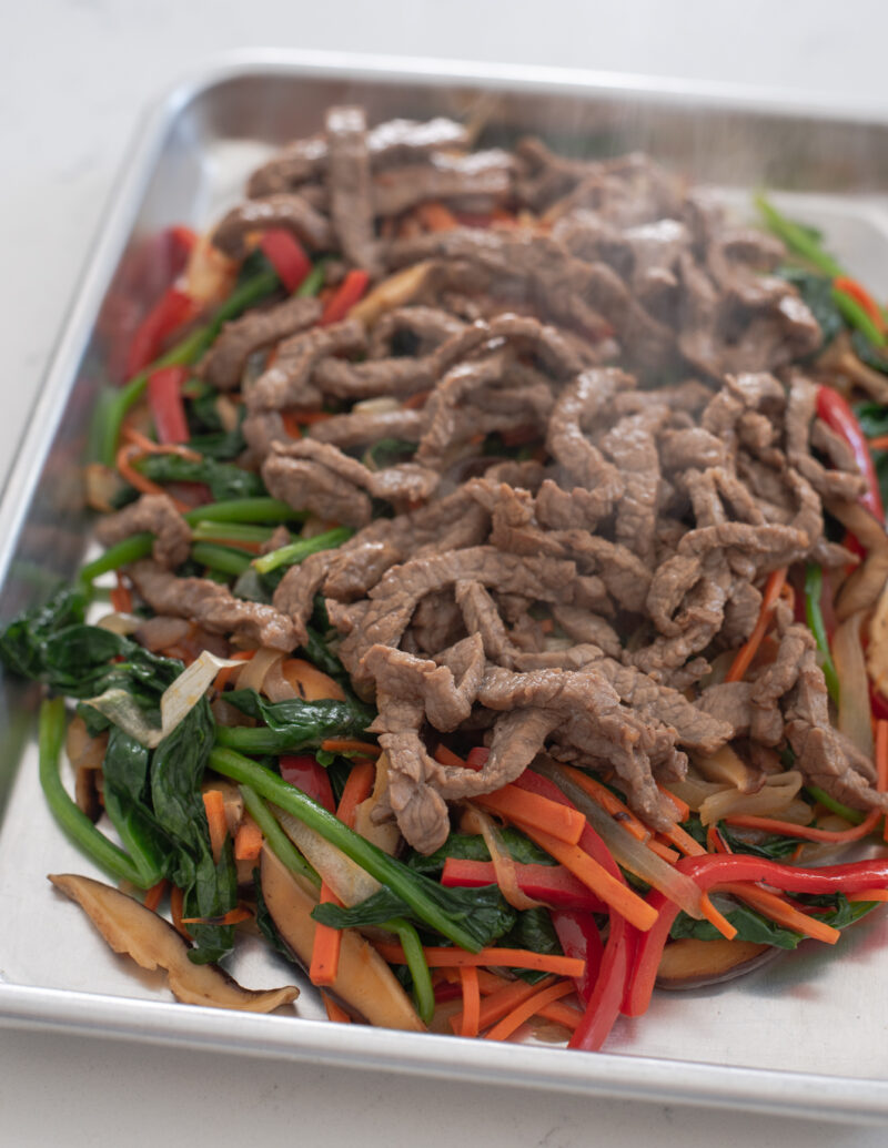 Browned beef and vegetables combined for japchae recipe.