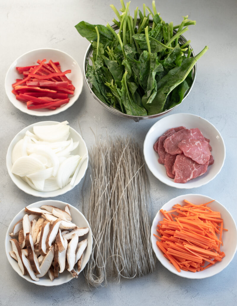 Each Japchae ingredient is placed in a bowl on the counter.