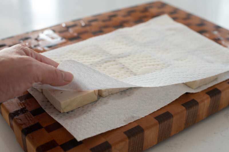Press each tofu slices gently with a piece of paper towel to remove excess water.