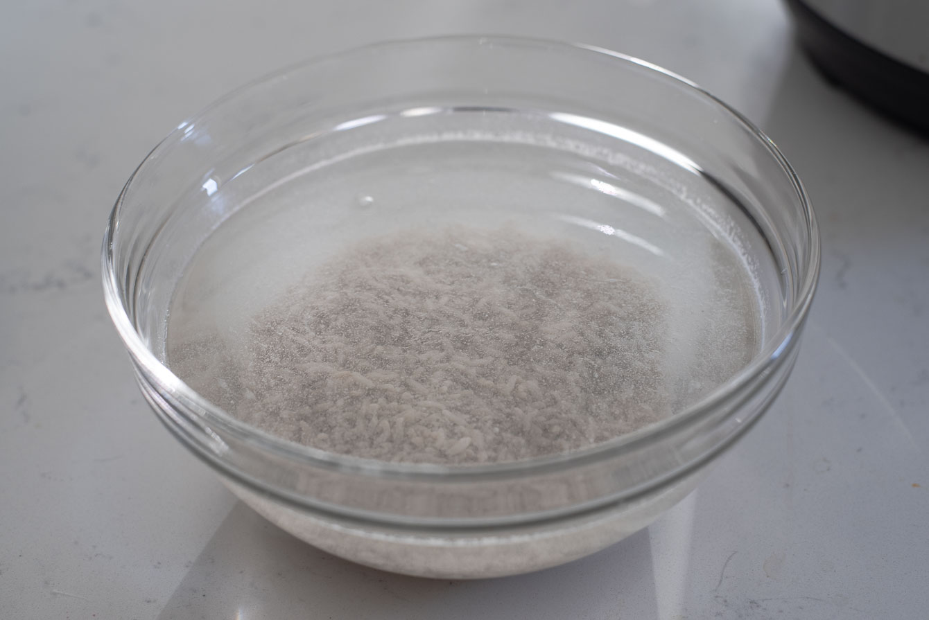 Fermented rice soaking in a bowl of cold water.