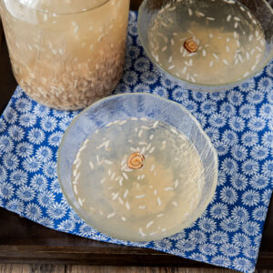 Korean rice drink served in glass bowls with jujube flower garnish.