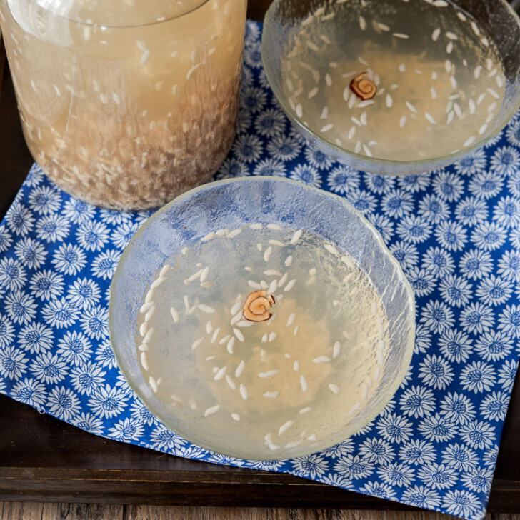 Korean rice drink served in glass bowls with jujube flower garnish.