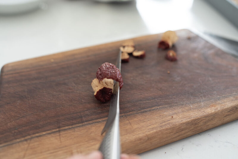 Dried jujube skin layer is cut around the seed.