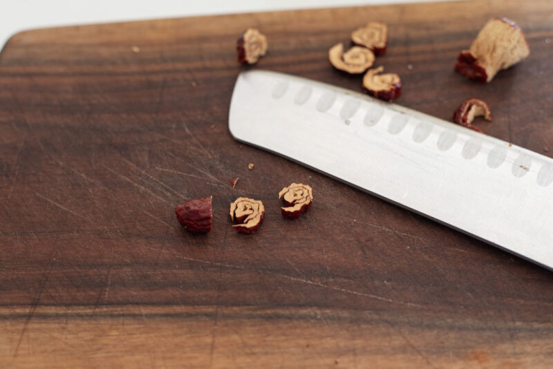 Jujube skin layer is rolled and sliced to make jujube flower to garnish Kroean dessert.