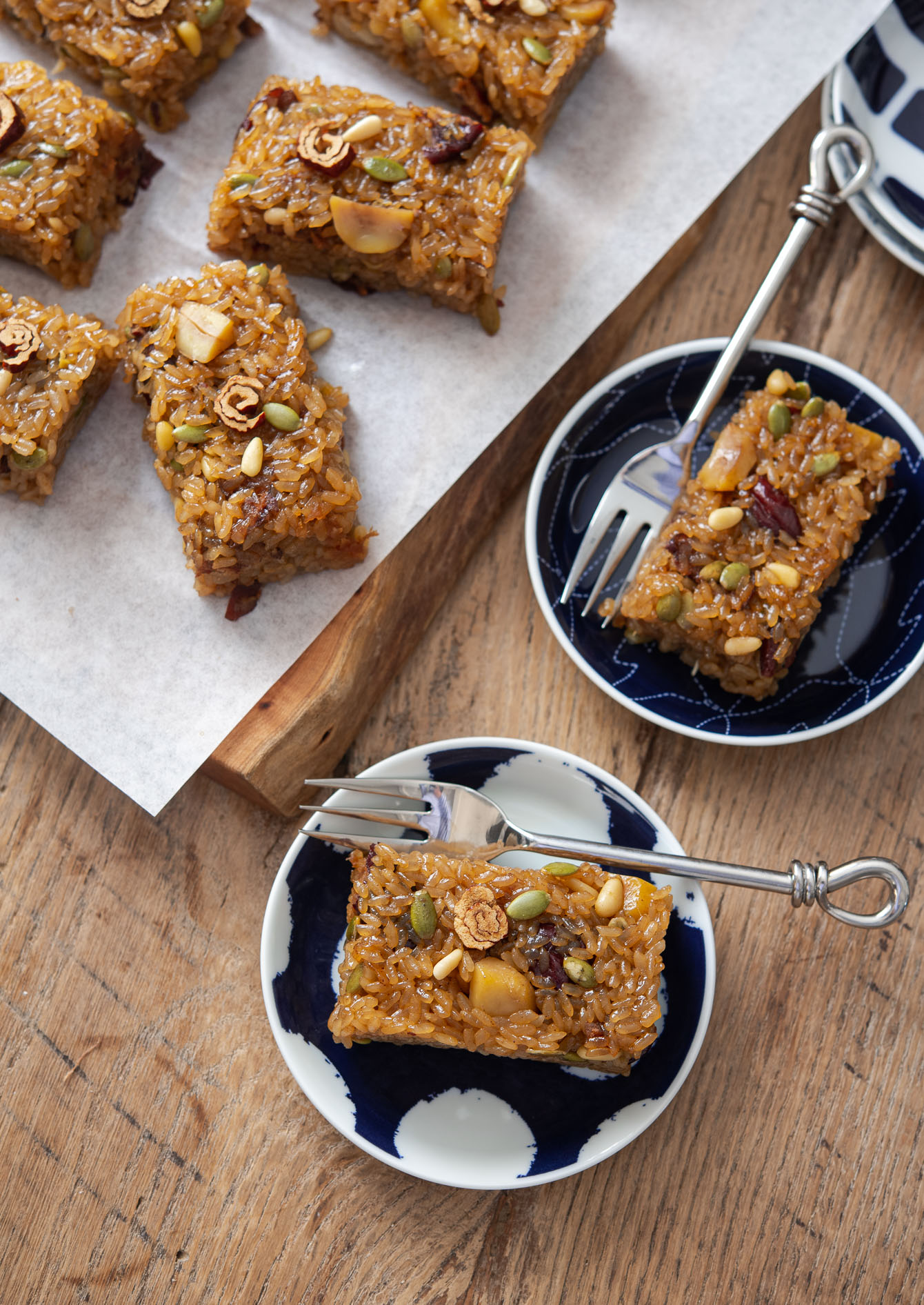 Sweet rice cakes slices (yakshik) served on dessert plates.
