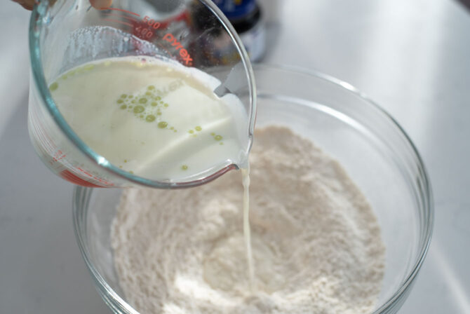 Pour milk and oil into the flour mixture of hotteok.