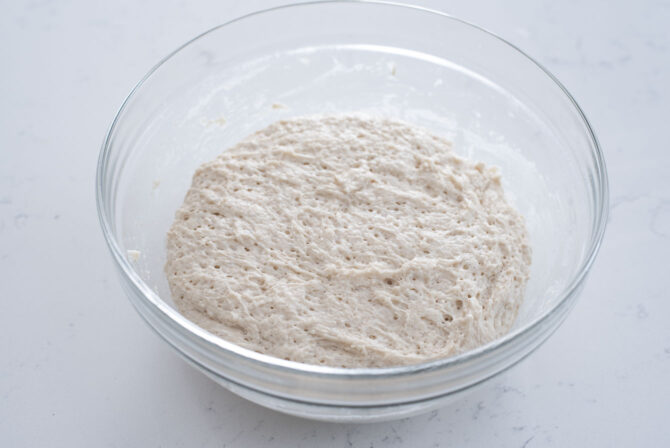 Hotteok dough has risen in volume in a bowl.