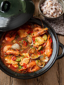 Korean soondubu jjigae with clam and shrimp is served with rice