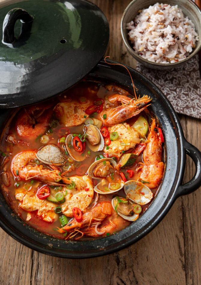 Sundubu jjigae (Korean Tofu Stew) with kimchi and seafood.