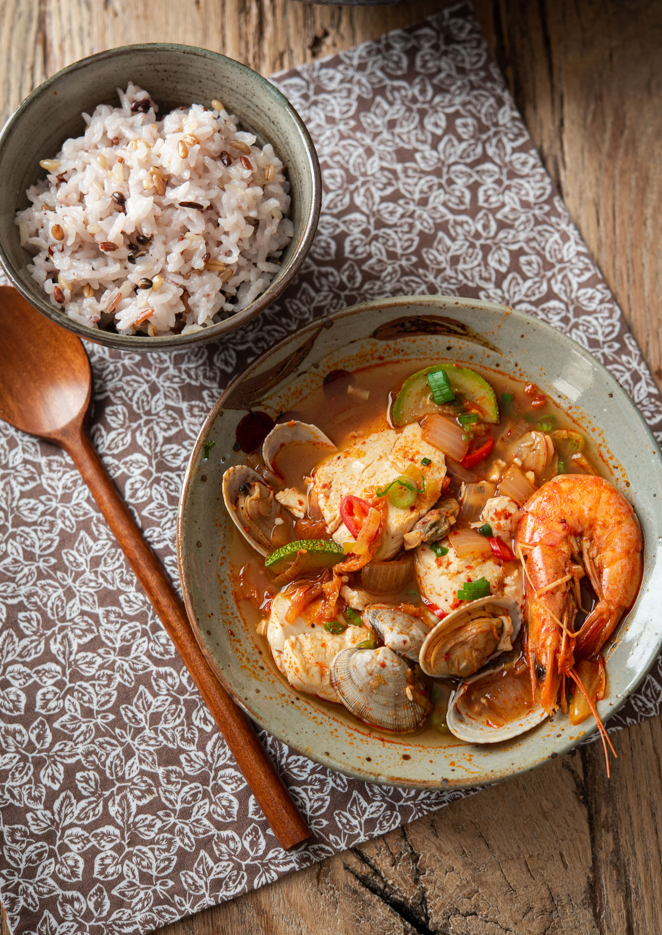 A bowl of sundubu jjigae served hot with rice
