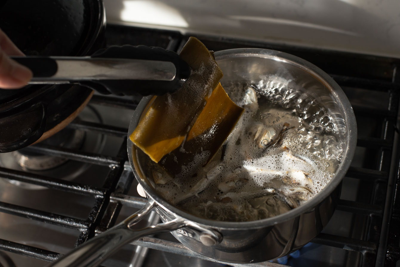 Dried anchovies and kelp simmering in water to make stock

