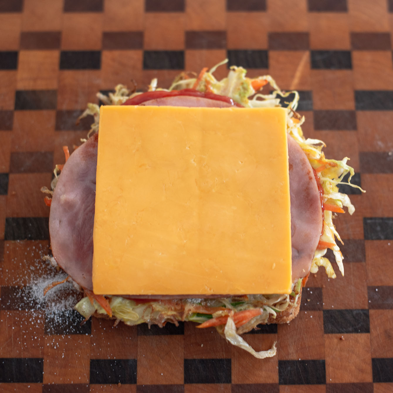 A slice of ham and cheese are used to assemble Korean street toast