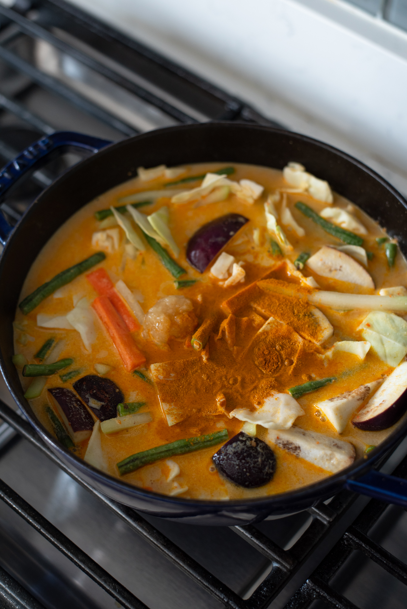 Vegetable curry with coconut milk uses tumeric powder to add flavor and color