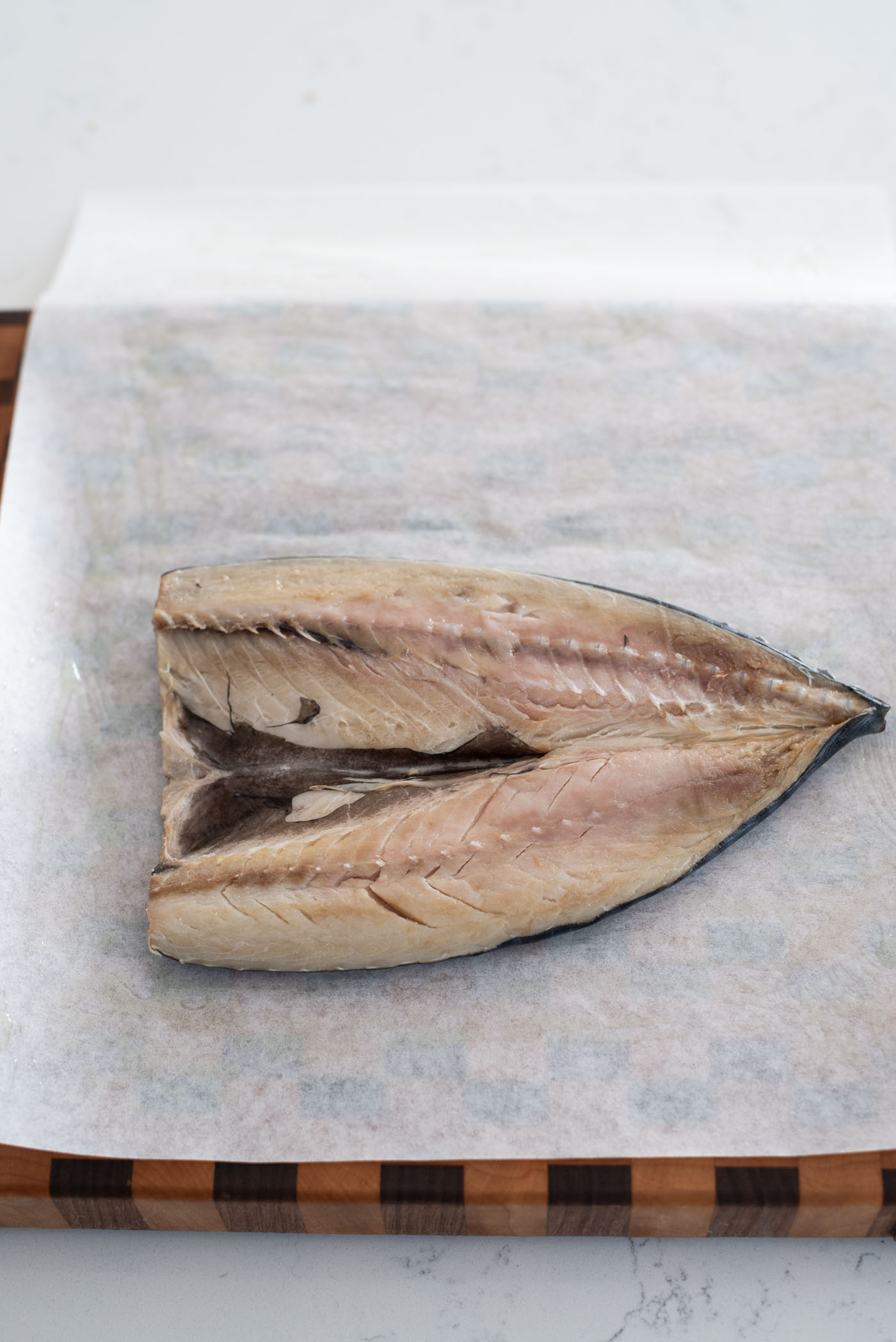 Mackerel fish on a greased parchment paper.
