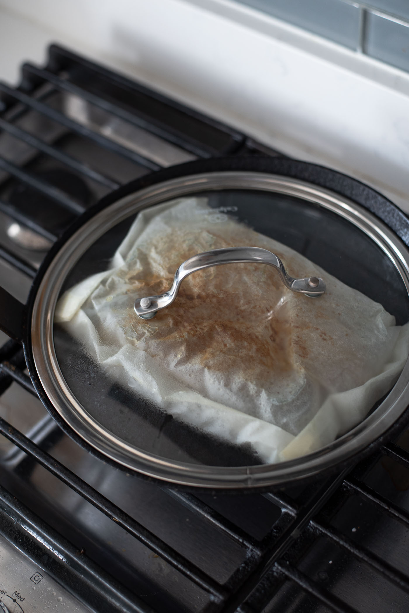 Mackerep fish in a parchment pouch covered with a lid.