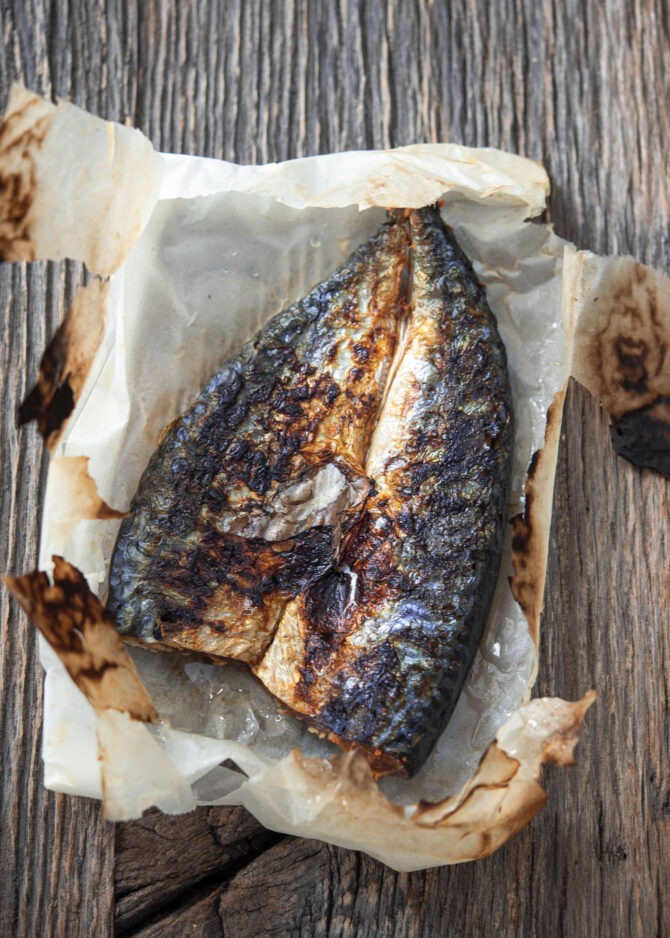 Mackerel fish is grilled to a perfection in a parchment paper