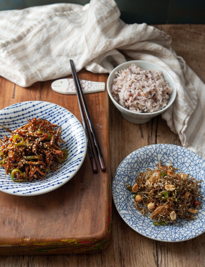 Two types of Korean anchovy side dishes are served with rice