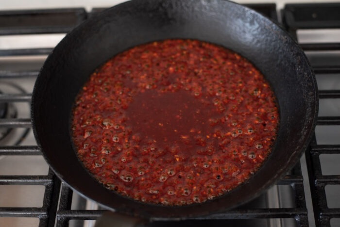 Gochujang sauce is boiling in a skillet