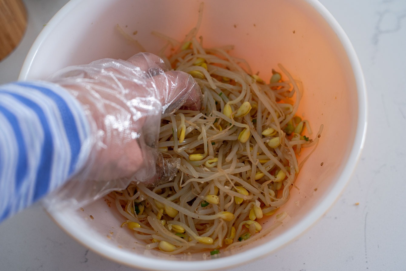 Steamed bean sprouts hand tossed to mix with the seasoning.