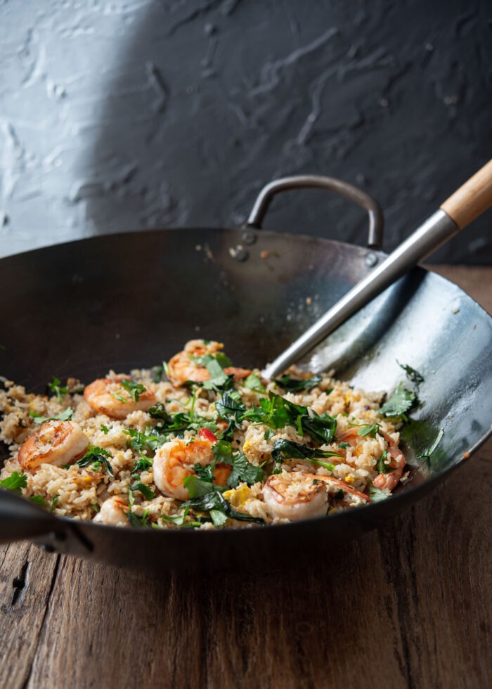 Thai style fried rice is made with Thai basil and shrimp in a wok