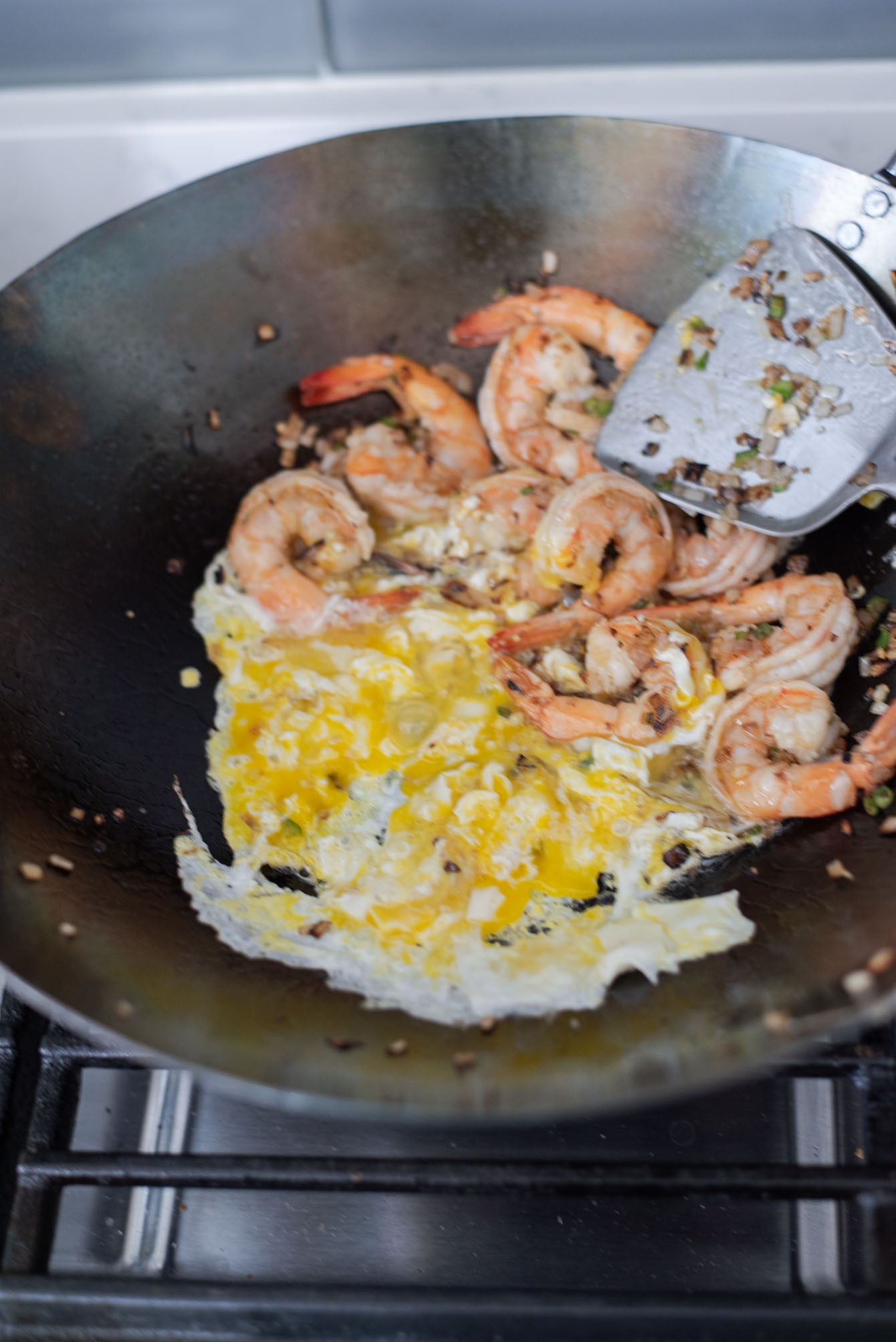 Eggs are scrambled in a wok with shrimp