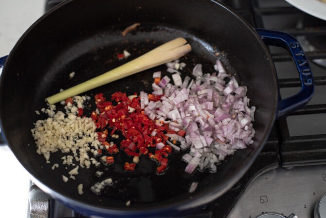 Shallot, red chili, garlic, and lemongrass are combined in a pot