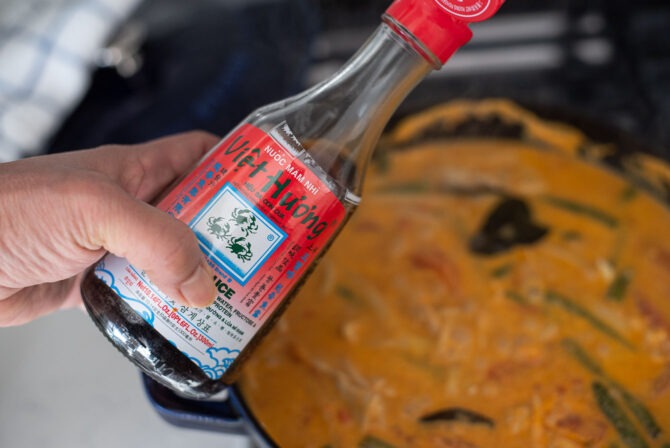 Fish sauce is added to season Thai red curry