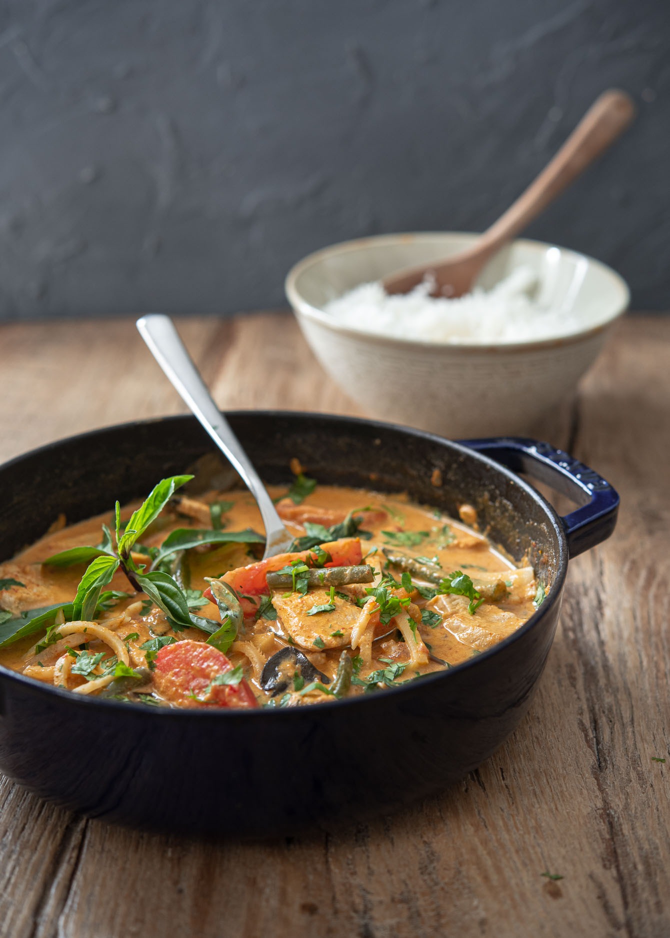 A pot of Thai red curry chicken served with rice