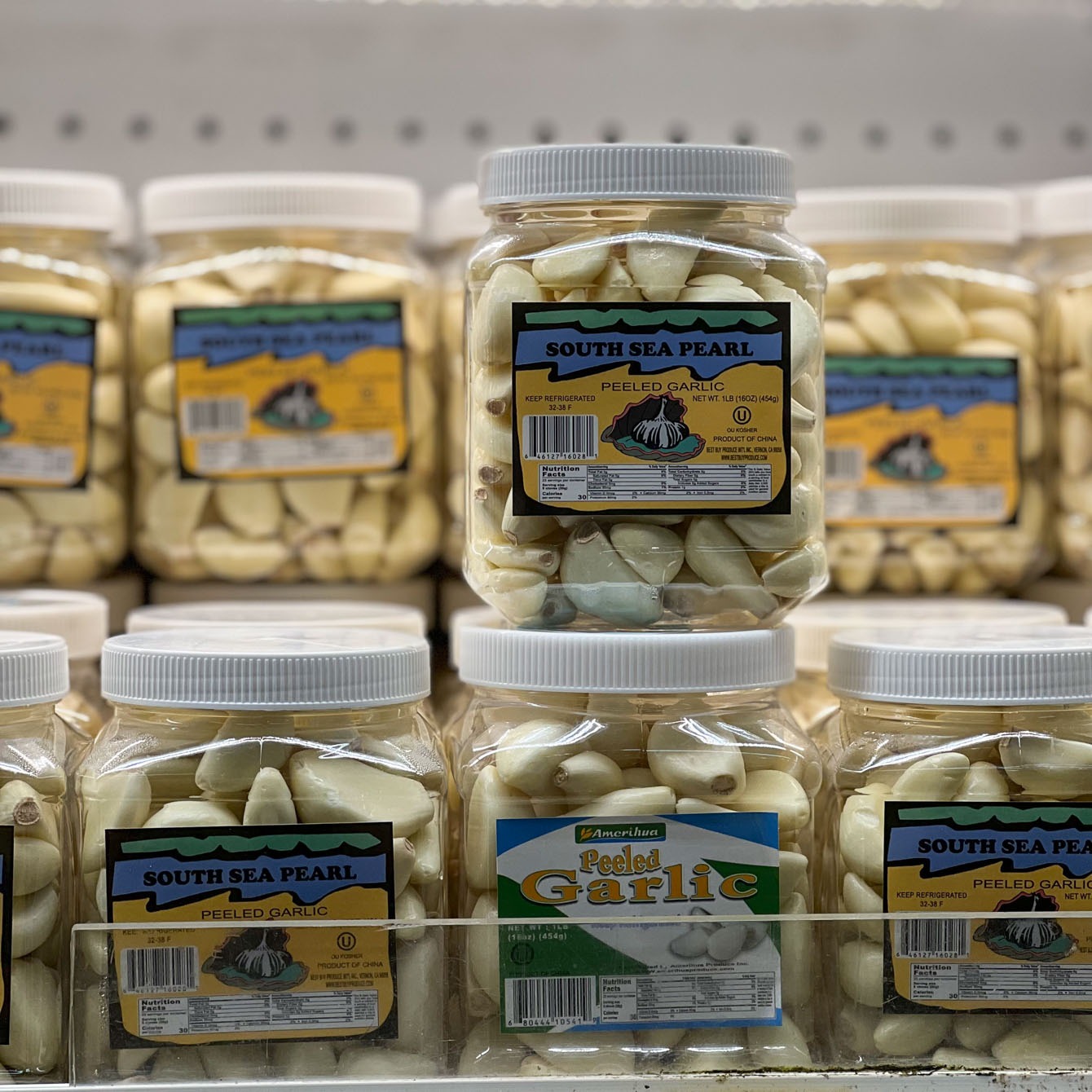 Peeled garlic cloves are sold in a jar