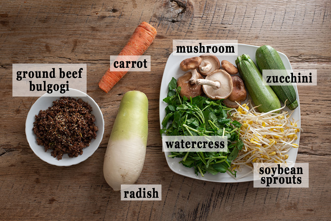 Various vegetables and ground beef bulgogi for making bibimbap recipe.