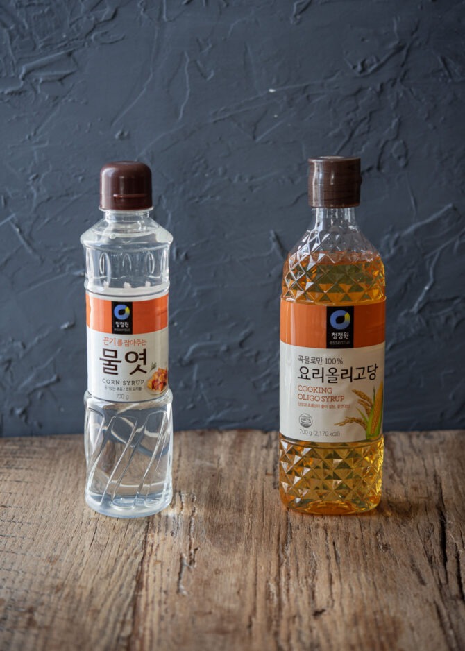 Clear Korean corn syrup and brown oligo syrup are presented together