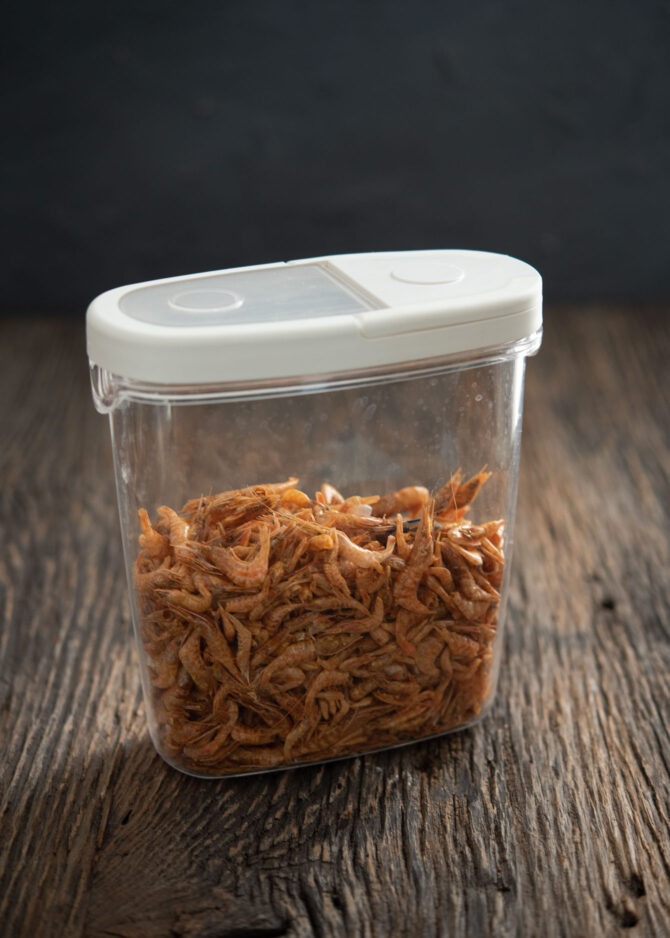 Dried shrimps are in a plastic container sealed with a lid