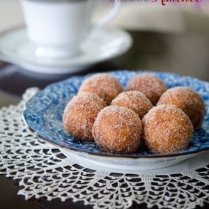 Sweet potato donuts are coated with cinnamon sugar and served with a tea.