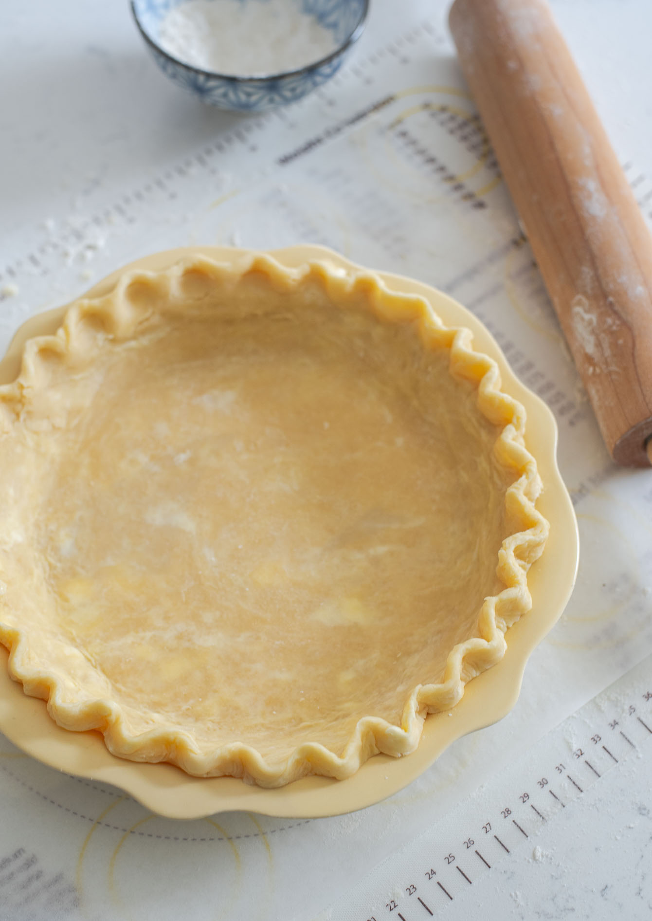 Fluted pie crust laid on a pie dish.