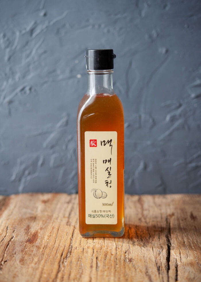 A bottle of Korean plum extract is displayed on the counter.