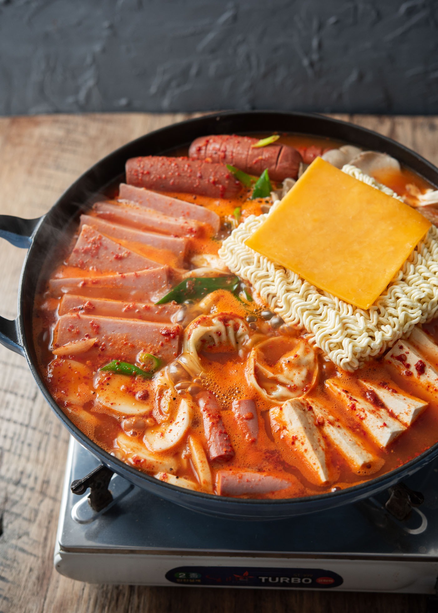 Budae jjigae known as Korean army stew boiling in a pot.