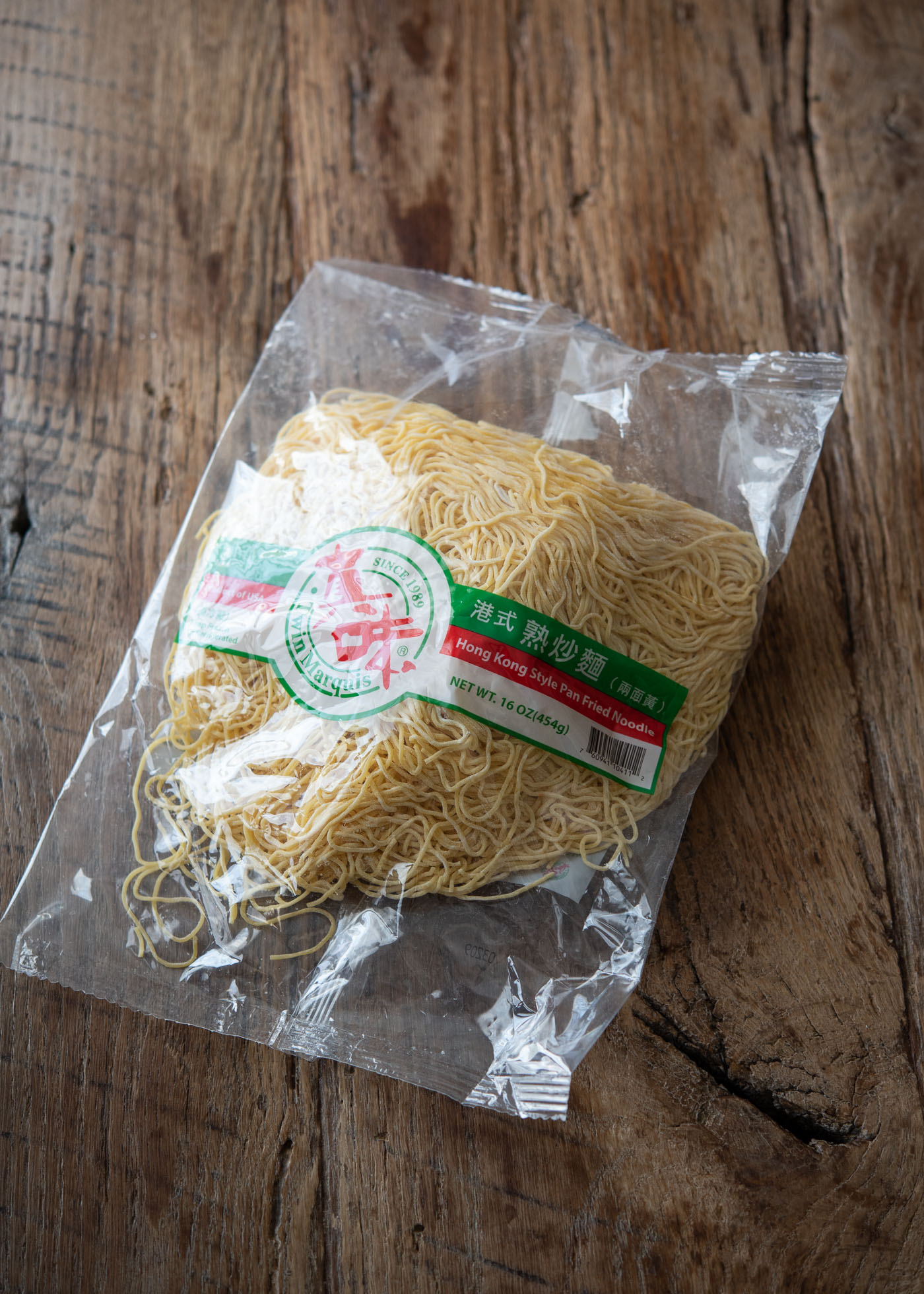 A package of fresh Hong Kong pan fried noodles is placed on a counter.