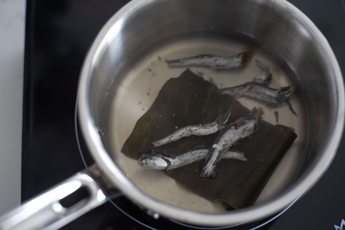 A pot of anchovy and sea kelp stock is simmering.