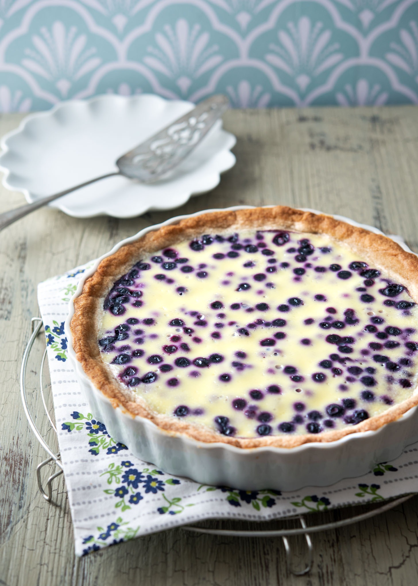 Finnish blueberry pie (Mustikkapiirakka) baked in a fluted pie dish.